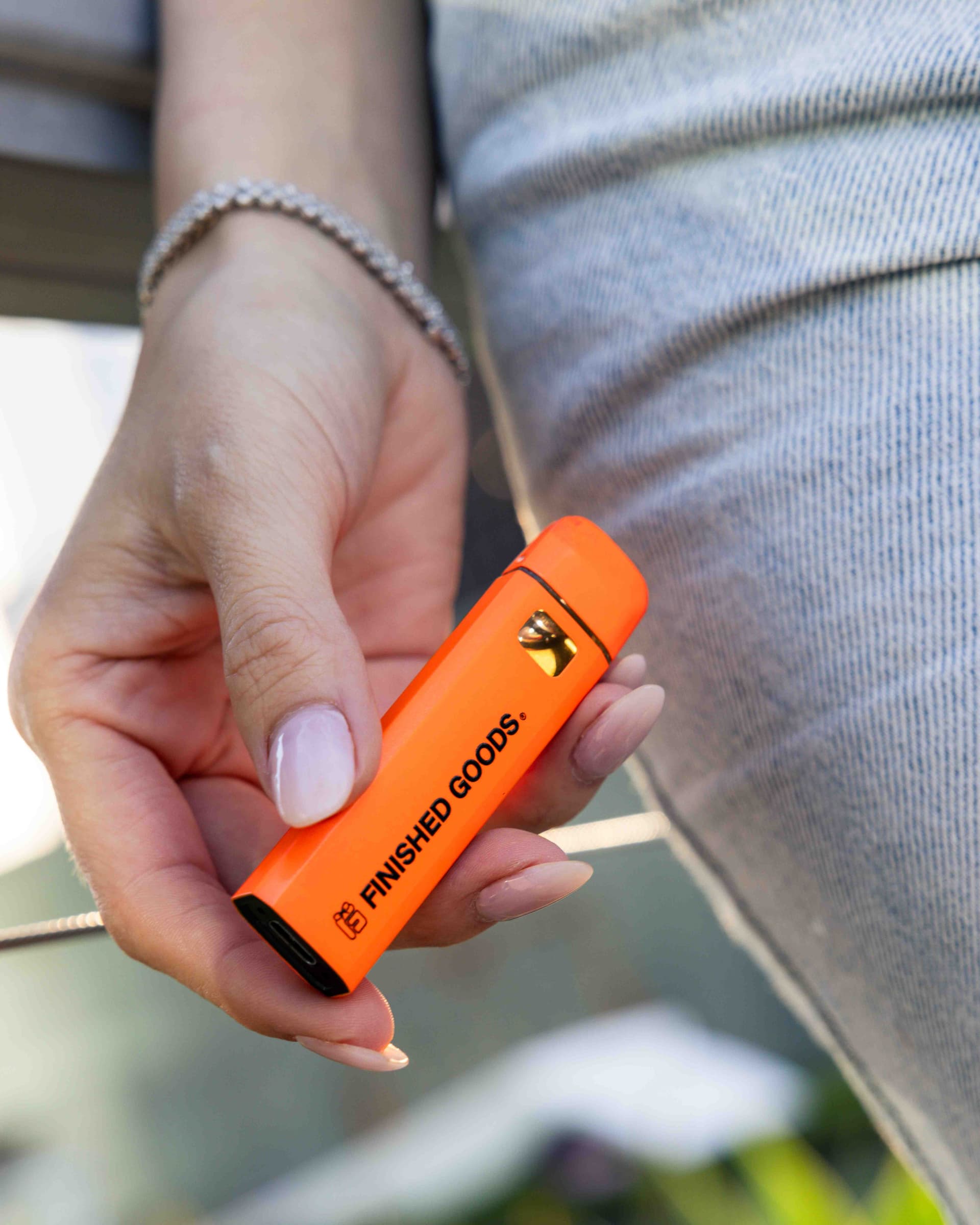 Hand holding Finished Goods vape device