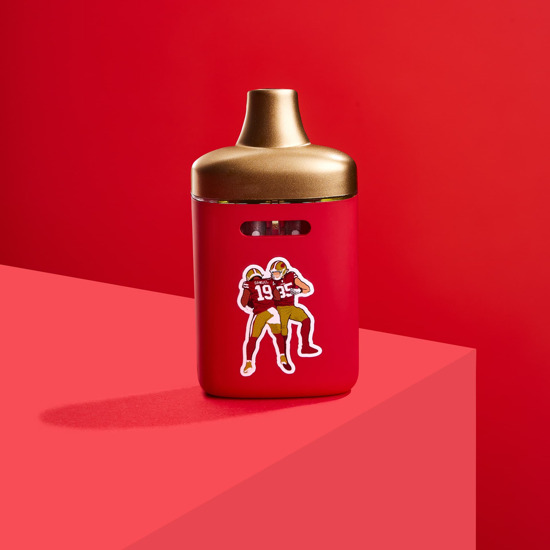 Red matte XL vape with gold mouthpiece and football players sticker