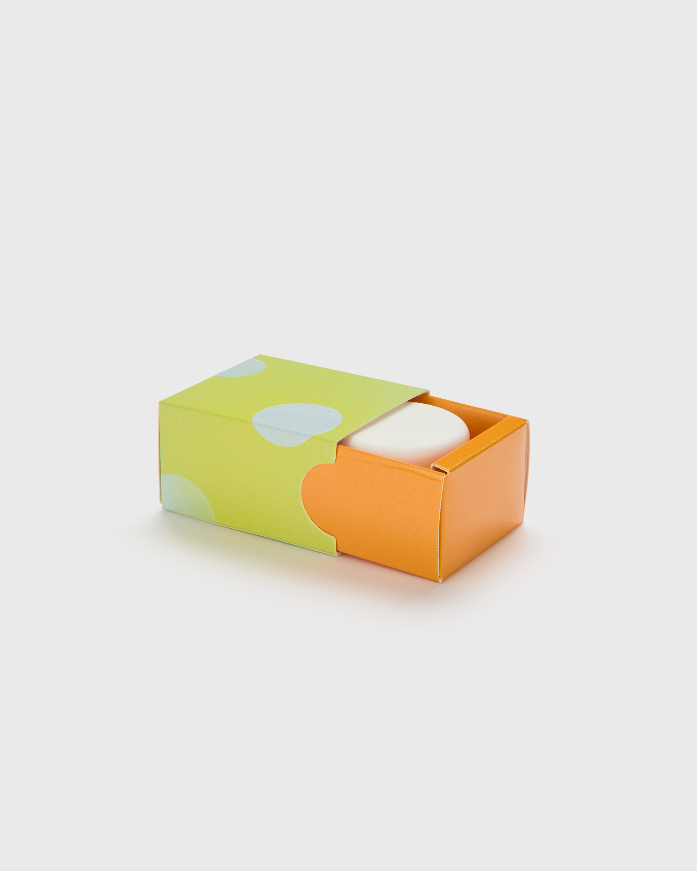 Concentrates slide box with green polka-dot sleeve partially open revealing orange tray and concentrate jar