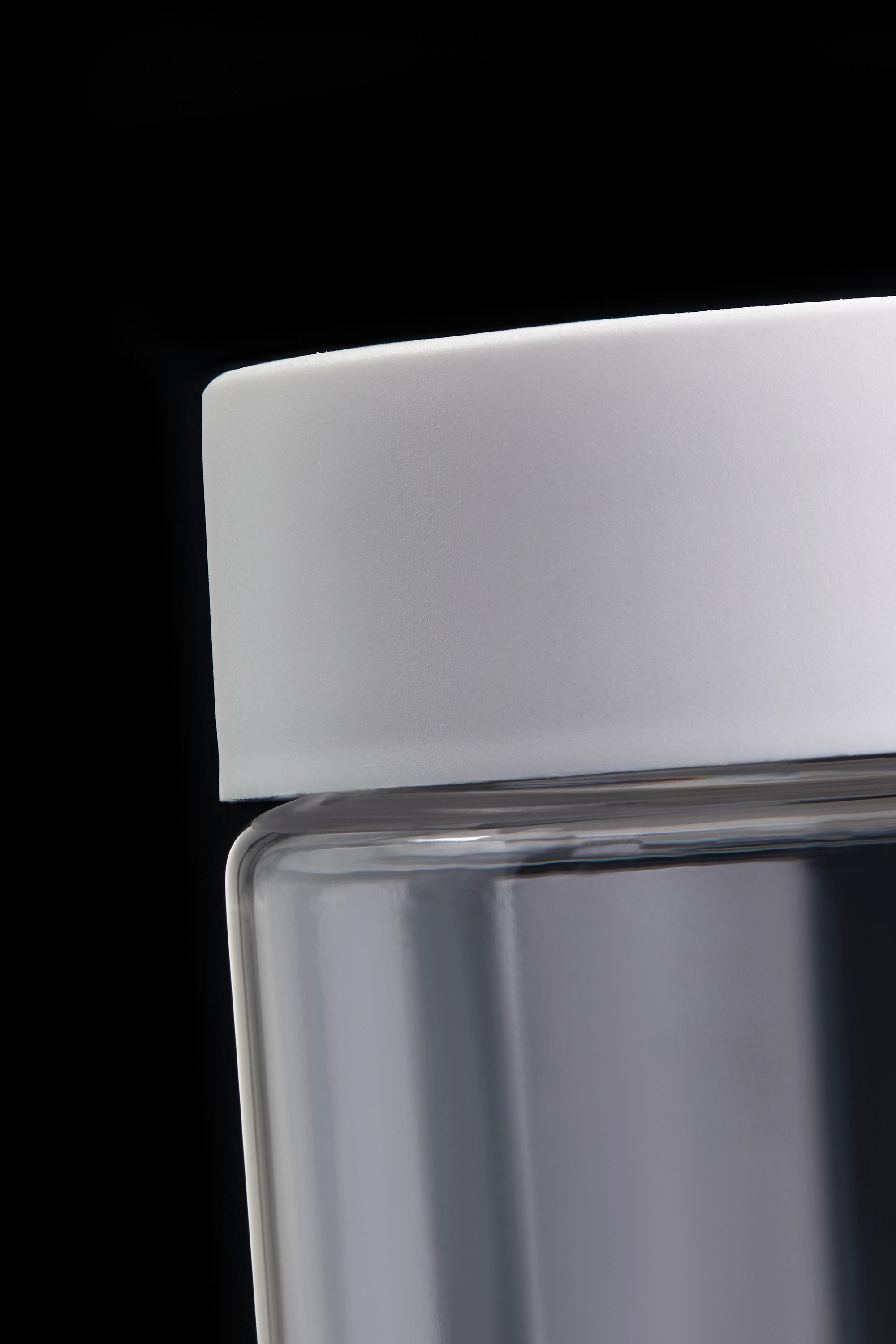 Close-up of child-resistant glass jar lid showing seal mechanism