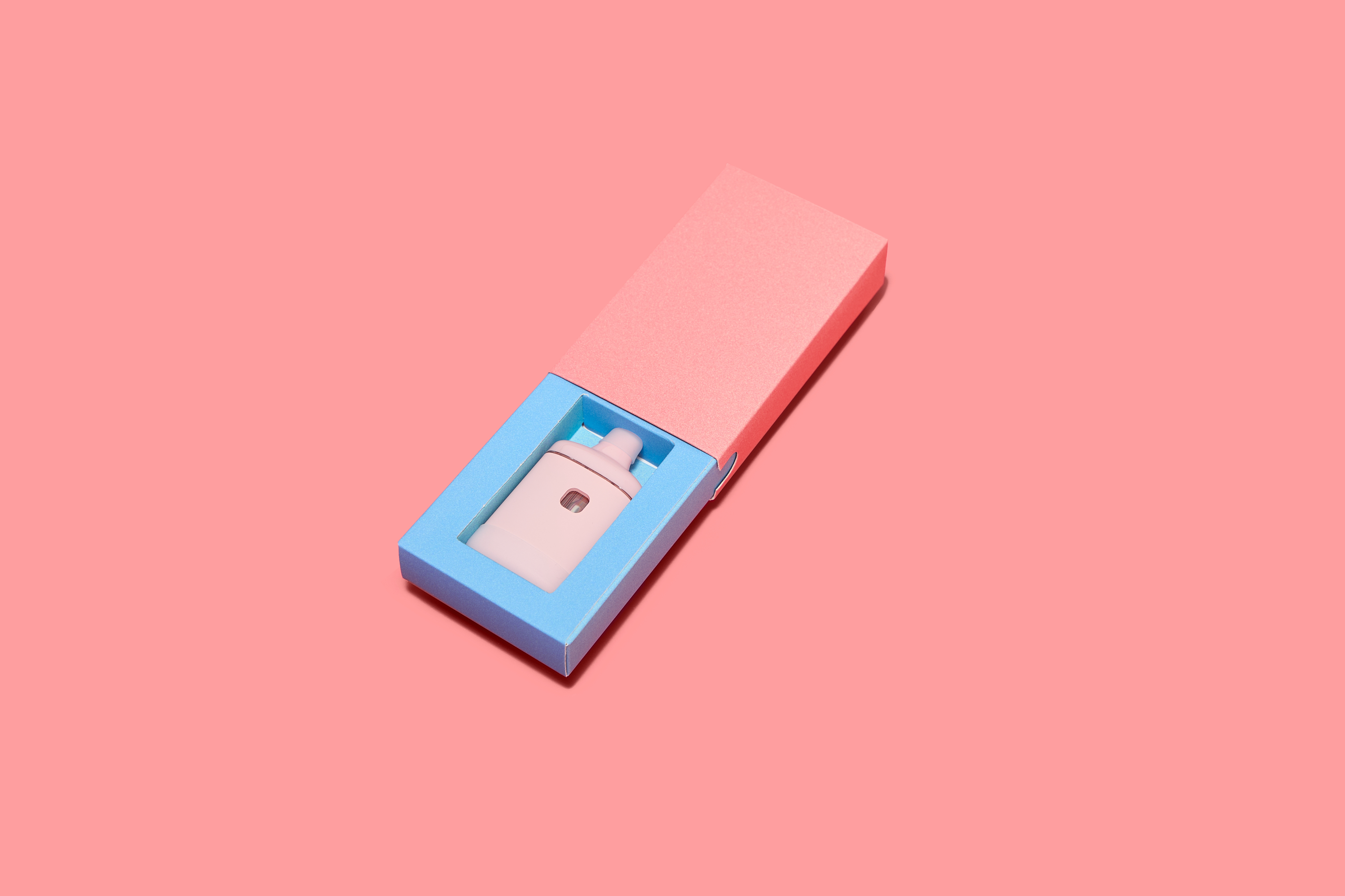 Paper slide box open showing blue interior tray with vaporizer