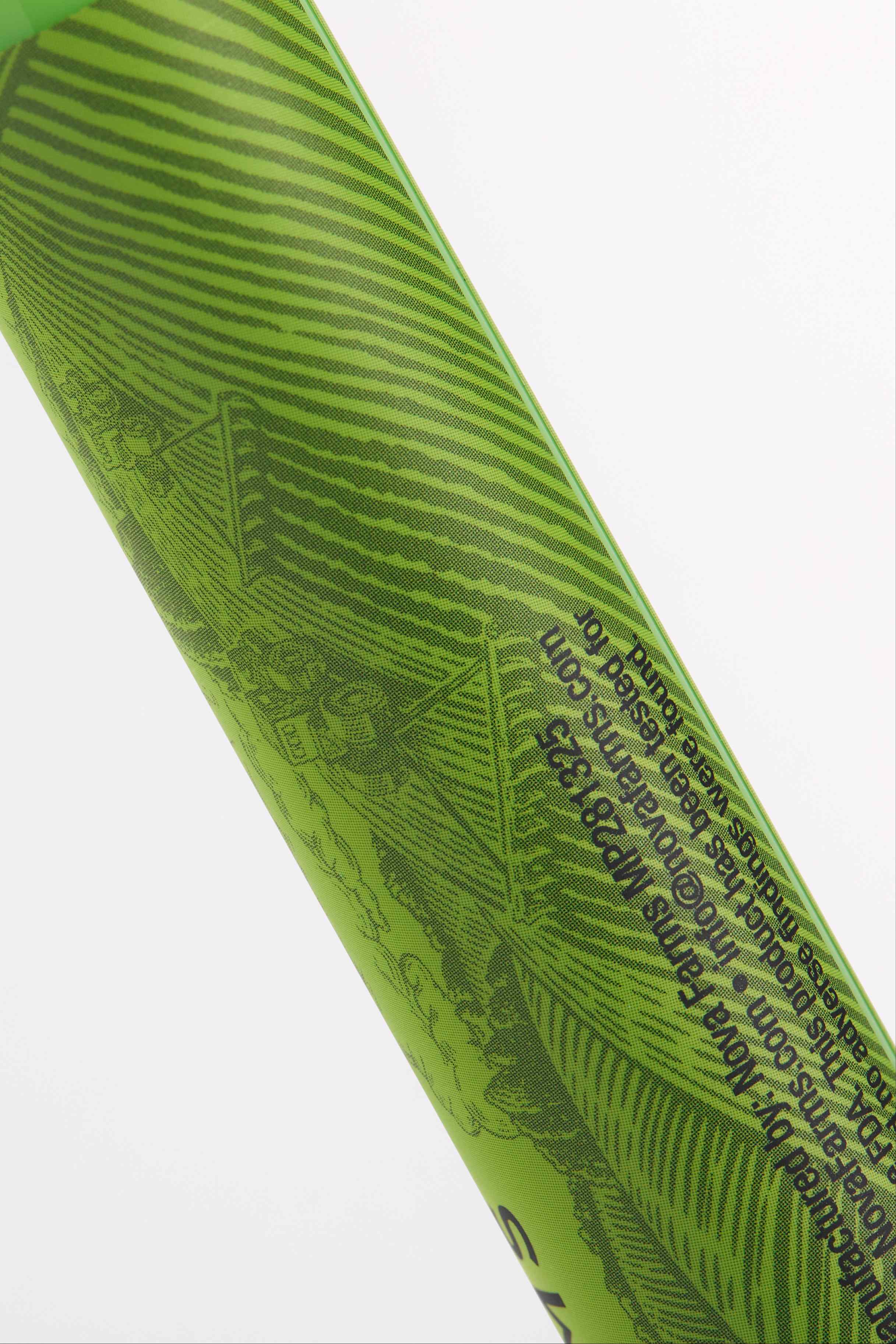 Custom labeled green pop top tube close-up